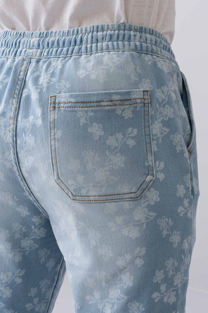 Close-up of the back pocket on Fashnica women's light blue floral print stretch denim jeans.