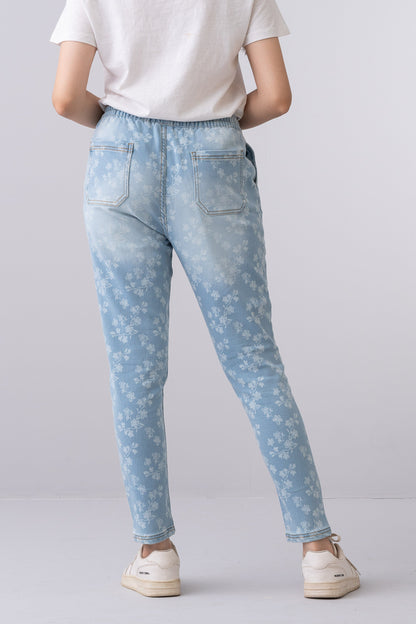 Back view of Fashnica women's light blue floral print stretch denim jeans with a regular fit and full-length design.