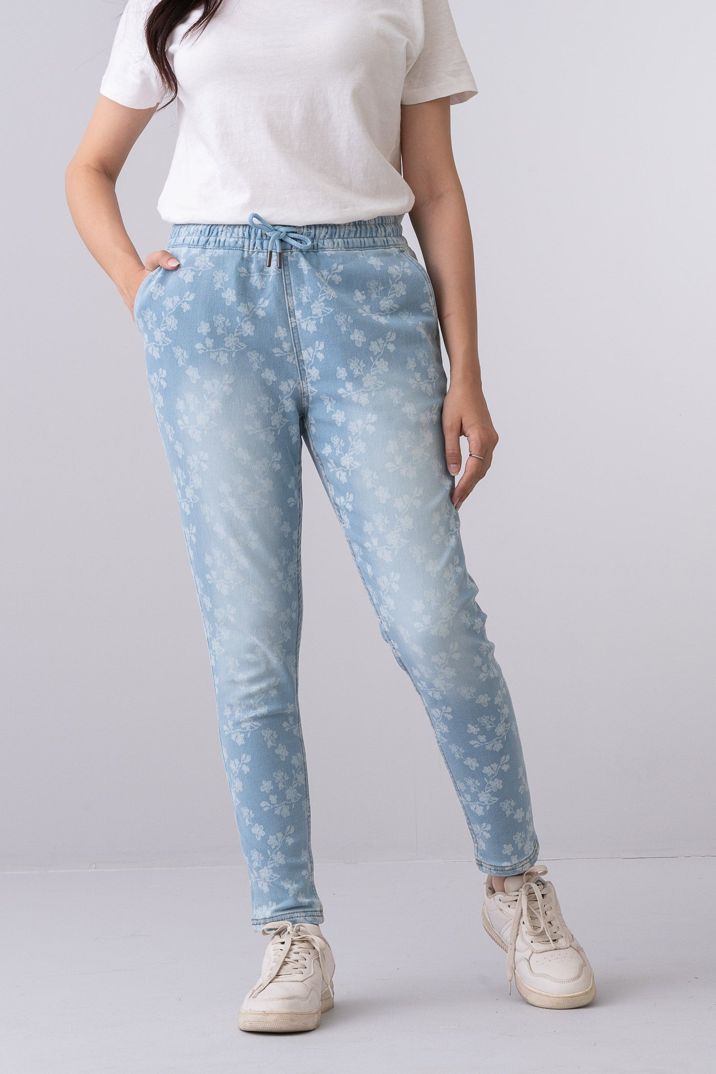 Fashnica women's light blue floral print stretch denim jeans featuring a regular fit, mid-rise waist, and elastic drawstring waistband.