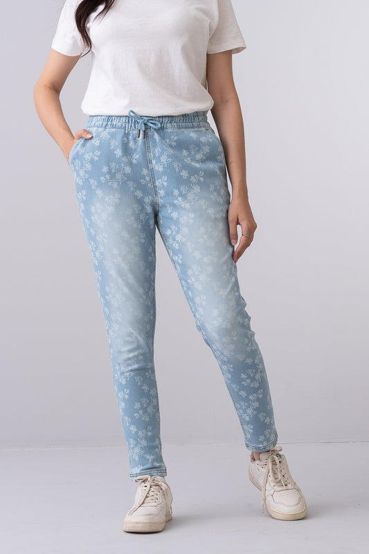 women's light blue floral print stretch denim jeans featuring a regular fit, mid-rise waist, and elastic drawstring waistband.
